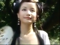 Beautiful Chinese Girl Walks Through A Garden